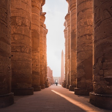 ancient corridor and columns of Karnak temple complex in Luxor city Egpyt during sunrise